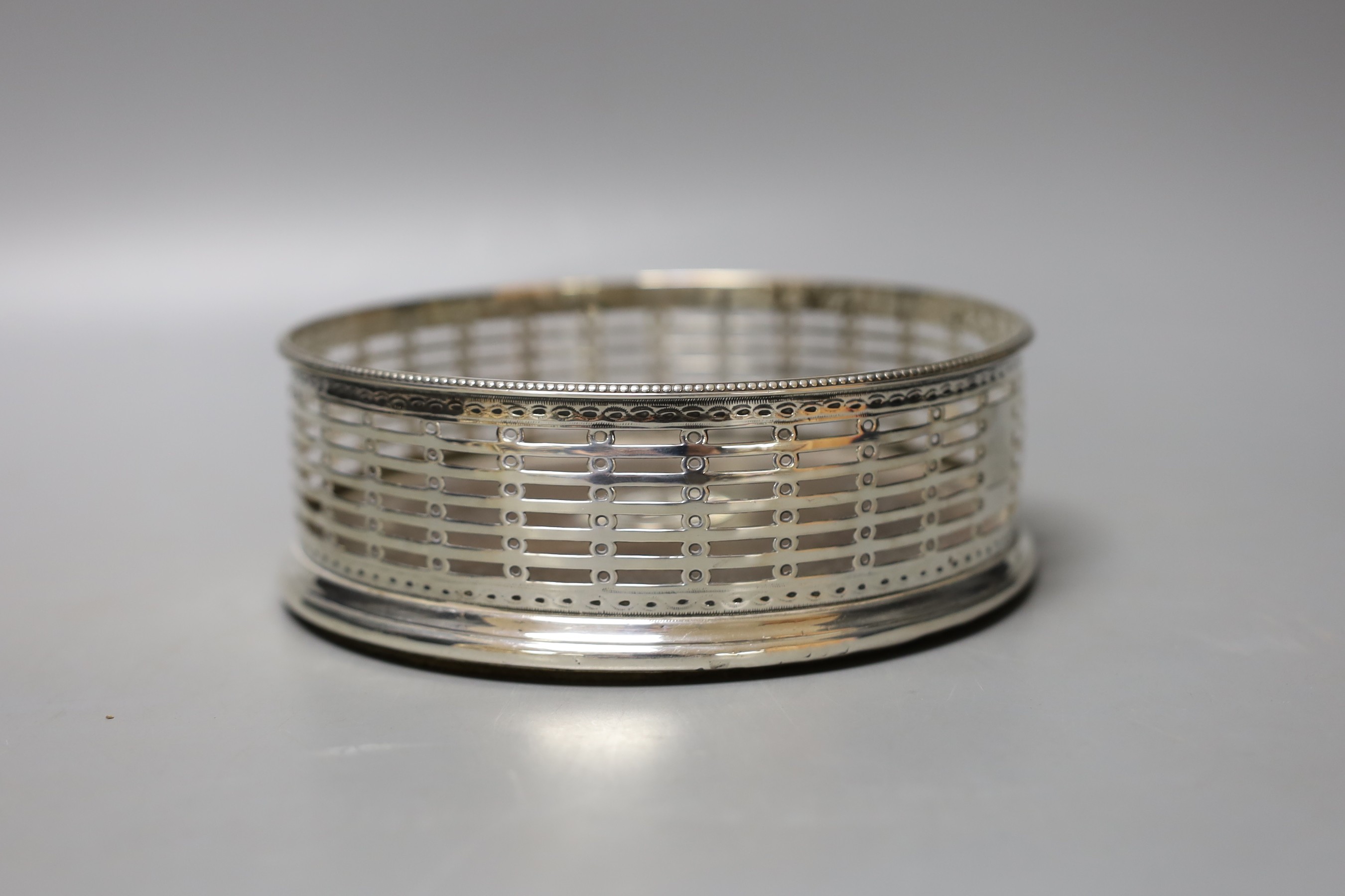 A 19th century pierced silver magnum coaster, marks rubbed, diameter 15.1cm.